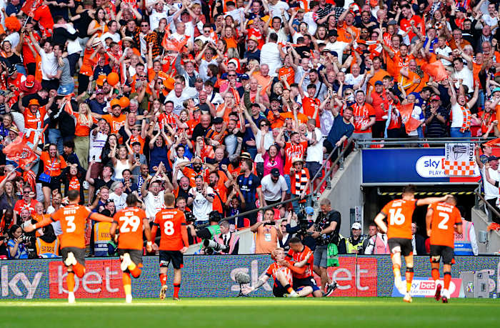 Players and fans from Luton Town pictured celebrating during the 2023 EFL Championship play-off final at Wembley