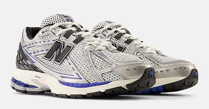 Side view of silver and black New Balance shoes.