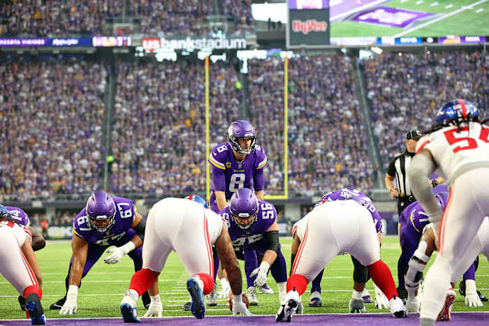 Minnesota Vikings center Garrett Bradbury prepares to snap the ball to quarterback Kirk Cousins, standing behind him, as Giants players line up opposite