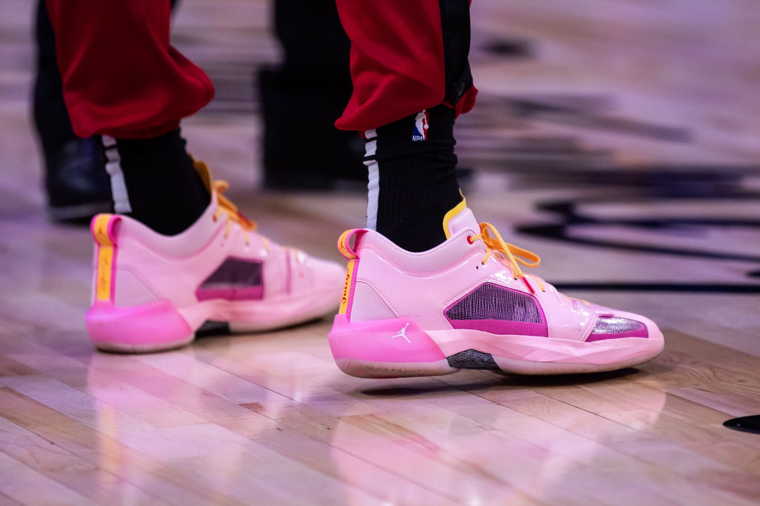 View of Bam Adebayo's pink and purple Air Jordan shoes.