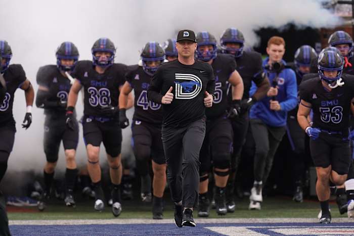 Nov 26, 2022; Dallas, Texas, USA; Southern Methodist Mustangs head coach Rhett Lashlee and the SMU Mustans take the field during the first half against the Memphis Tigers at Gerald J. Ford Stadium. Mandatory Credit: Chris Jones-USA TODAY Sports