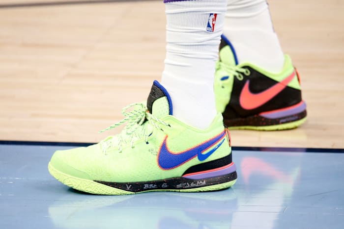 View of LeBron James' green and blue Nike shoes.