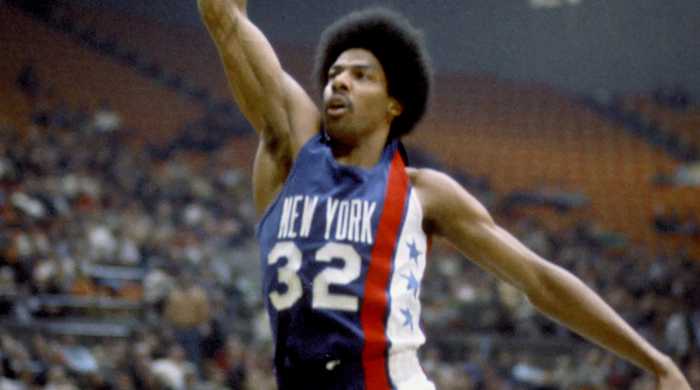 Forward Julius Erving dunks for the Nets of the American Basketball Association.