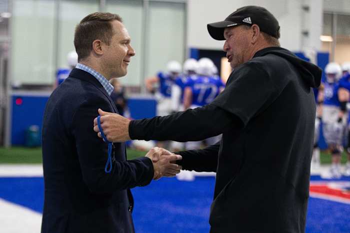 Kansas head coach Lance Leipold meets with athletic director Travis Goff during Thursday's practice.