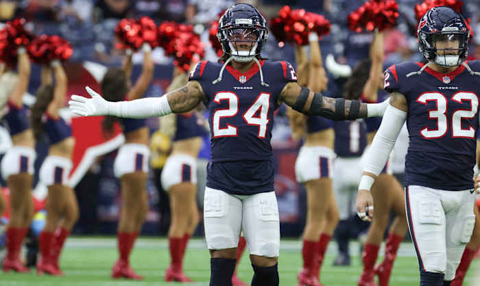 Houston Texans cornerback Derek Stingley Jr. stands on the field with his arms wide