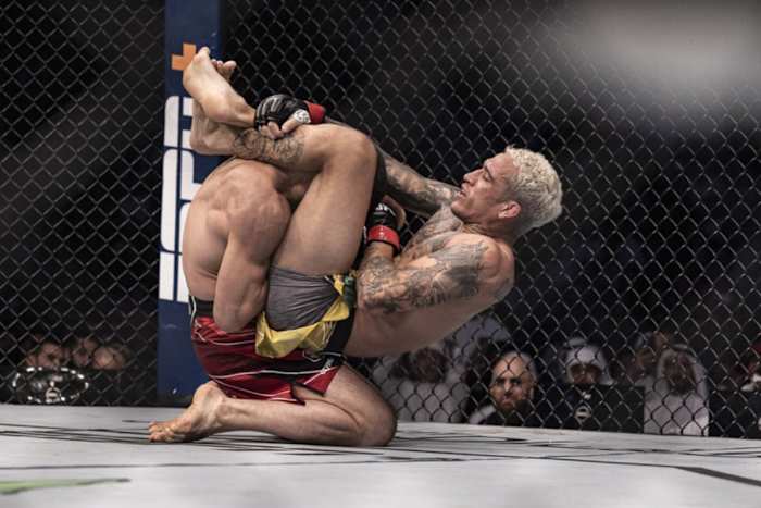 Charles Oliveira attempts a triangle choke on Islam Makhachev during their UFC Lightweight Championship fight.