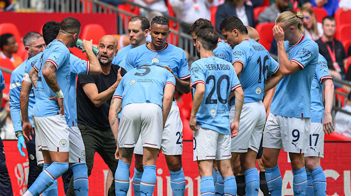 Pep Guardiola discusses strategy and tactics with his Manchester City squad during the 2023 FA Cup final vs. Manchester United.