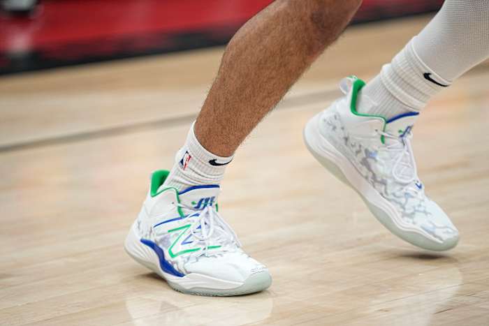 View of Jamal Murray's white, green, and blue New Balance shoes.
