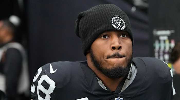 Raiders running back Josh Jacobs (28) warms up before a game against the Patriots at Allegiant Stadium.