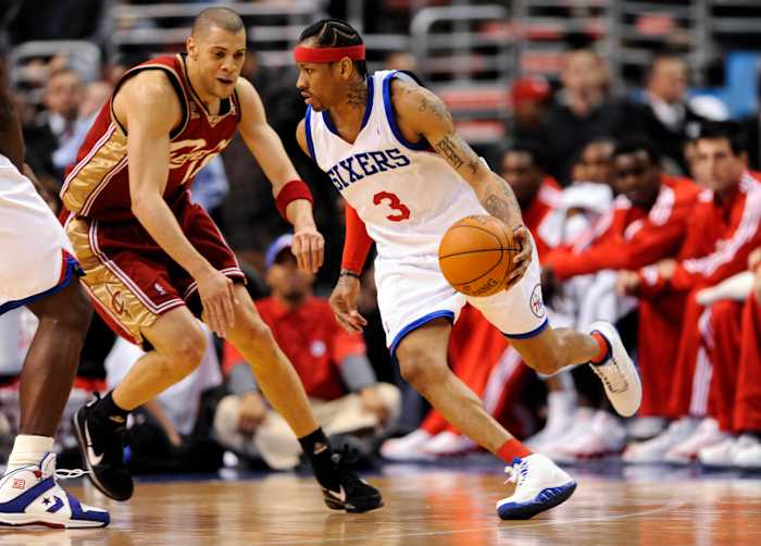 Philadelphia 76ers guard Allen Iverson dribbles by Cleveland Cavaliers guard Anthony Parker.