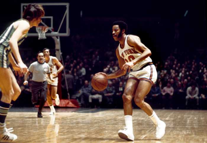 New York Knicks guard Walt Frazier dribbles the ball against the Atlanta Hawks defense.