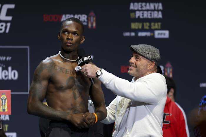 Israel Adesanya is interviewed by UFC color commentator Joe Rogan at the UFC 281 ceremonial weigh-ins.