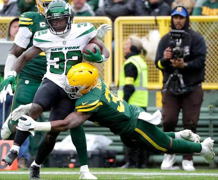 Safety Adrian Amos attempts to tackle Jets' RB Michael Carter during a 2022 game