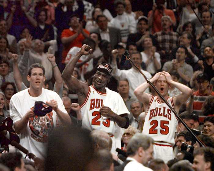 Jun 13, 1997; Chicago, IL, USA; Chicago Bulls players Judd Buechler, left, Michael Jordan, middle, and Steve Kerr celebrate after winning the NBA championship after defeating the Utah Jazz in the 1997 NBA Finals at the United Center.