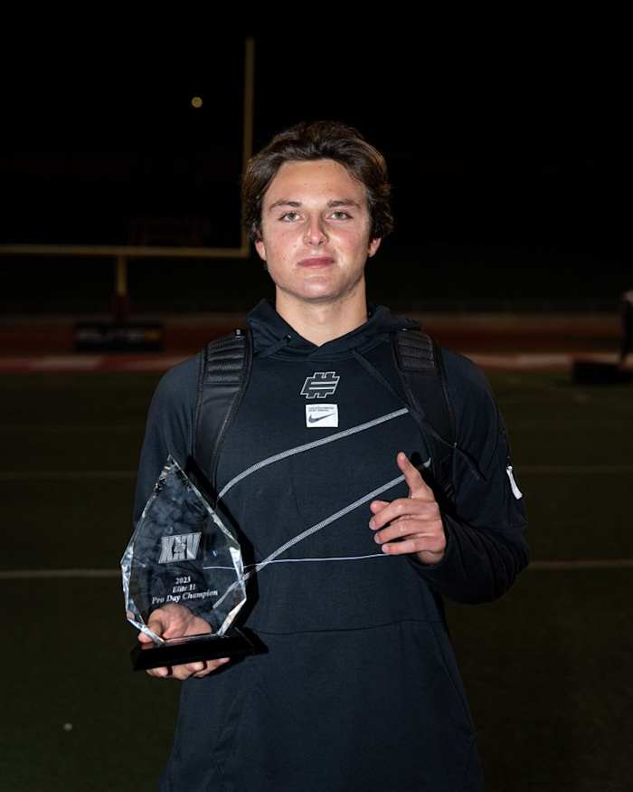 Julian Sayin holds the first-place trophy for the Elite 11 Pro Day competition