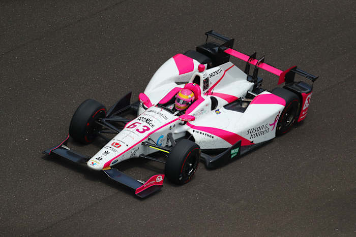 Mann in her pink helmet and car during the 2017 Indy 500.