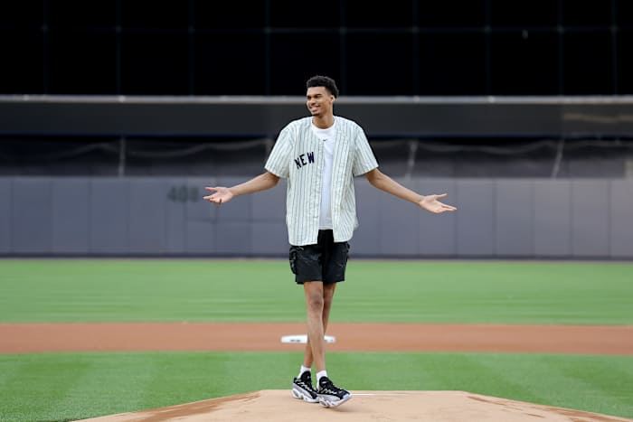Victor Wembanyama reacts after throwing out the first pitch before a New York Yankees game.