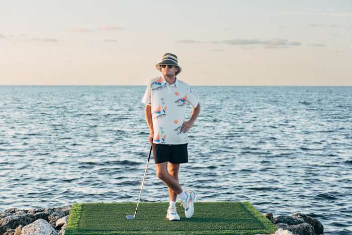 Rickie Fowler models Puma golf apparel on the beach.
