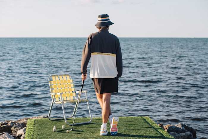 Rickie Fowler models Puma Golf apparel on a beach.