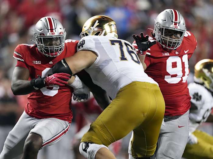 Sep 3, 2022; Columbus, Ohio, USA; Ohio State Buckeyes defensive end Zach Harrison (9) and Ohio State Buckeyes defensive tackle Tyleik Williams (91) rush against Notre Dame Fighting Irish offensive lineman Joe Alt (76) in the fourth quarter at Ohio Stadium. Mandatory Credit: Kyle Robertson-USA TODAY Sports
