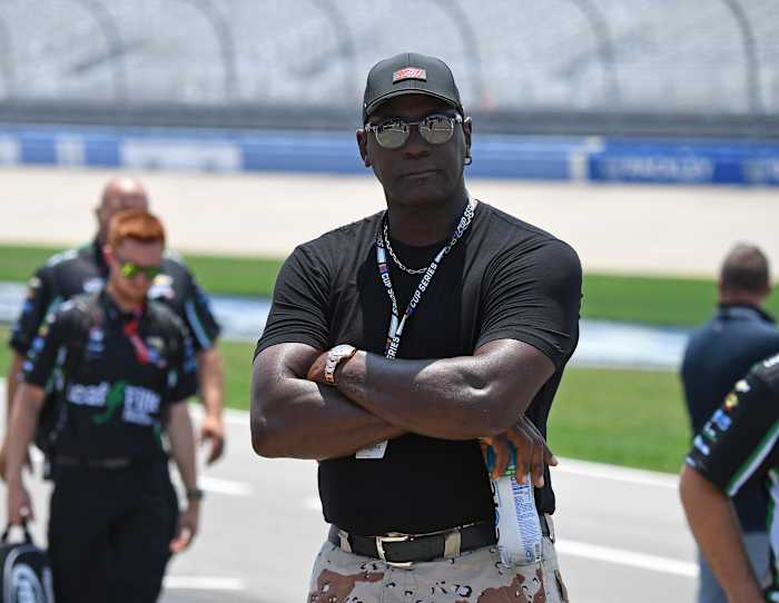 Michael Jordan looks on from the pit road at a NASCAR event.