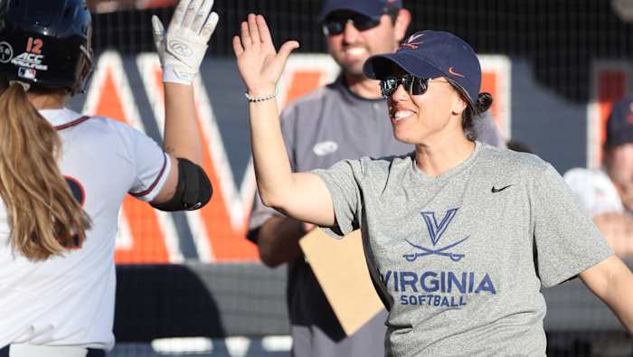 Virginia head coach Joanna Hardin high fives Lauren VanAssche during the UVA softball game against Longwood at Palmer Park.