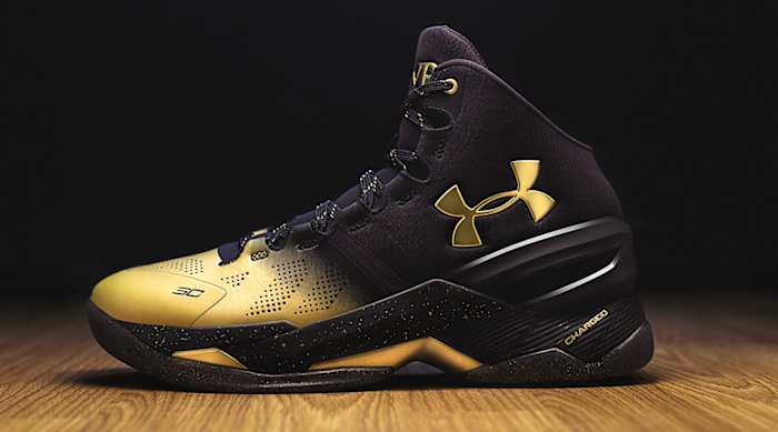 Side view of Stephen Curry's black and gold Under Armour shoe.