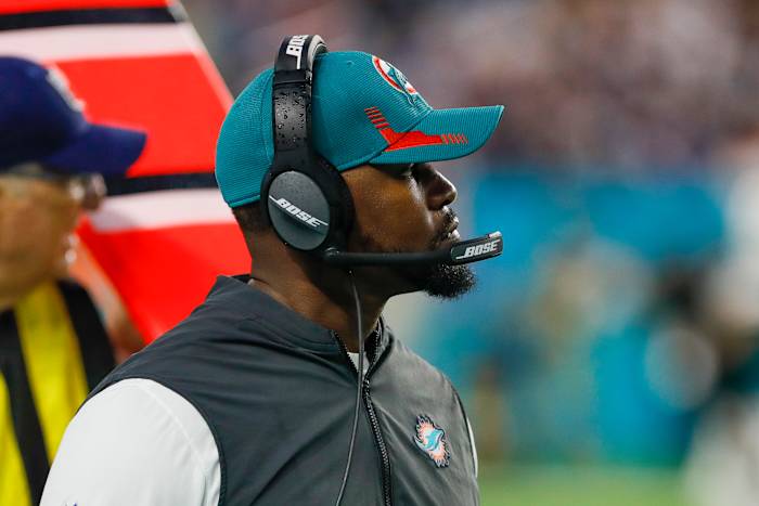 Brian Flores wearing a dolphins hat and headset
