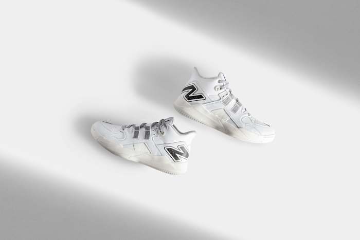 Side view of Coco Gauff's white and black New Balance tennis shoes.