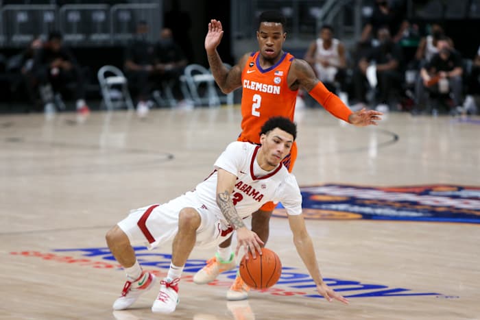 Dec 12, 2020; Atlanta, Georgia, USA; Alabama Crimson Tide guard Jahvon Quinerly (13) dribbles defended by Clemson Tigers guard Al-Amir Dawes (2) in the first half of a Holiday Hoopsgiving game at State Farm Arena. Mandatory Credit: Brett Davis-USA TODAY Sports