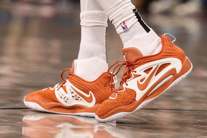 View of Kevin Durant's orange and white Nike shoes.