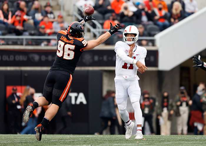 Nov 13, 2021; Corvallis, Oregon, USA; Stanford Cardinal quarterback Ari Patu (11) throws under pressure from Oregon State Beavers defensive lineman Simon Sandberg (96) during the first half at Reser Stadium. Mandatory Credit: Soobum Im-USA TODAY Sports