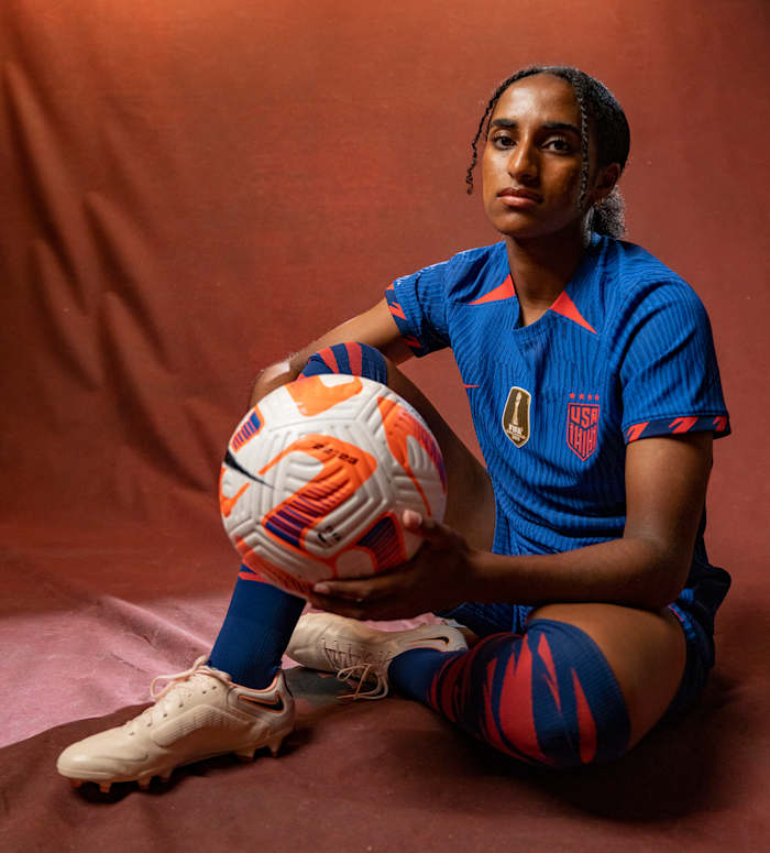 U.S. women's national team defender Naoimi Girma poses with a soccer ball.