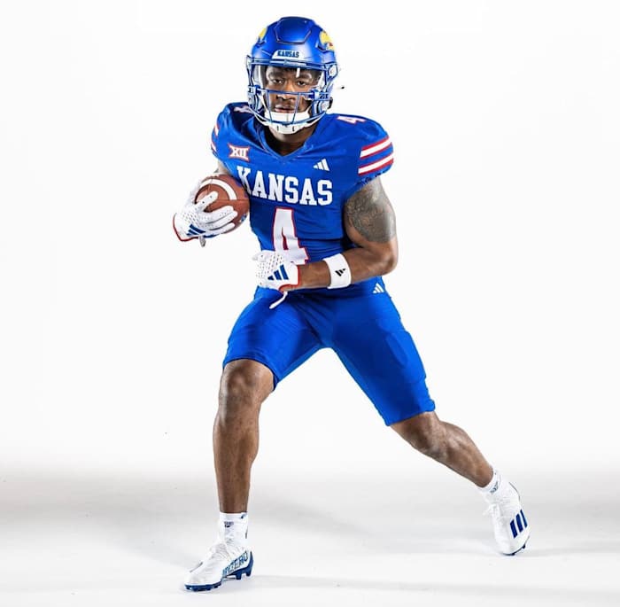 Devin Neal wears the new blue uniforms unveiled by the Kansas Jayhawks on July 10, 2023.