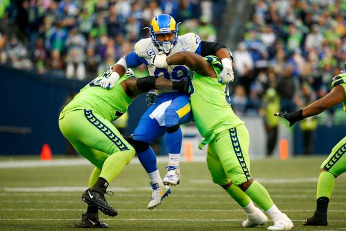 Oct 7, 2021; Seattle, Washington, USA; Los Angeles Rams defensive end Aaron Donald (99) is blocked by Seattle Seahawks offensive tackle Duane Brown (76, left) and guard Damien Lewis (68, right) during the second quarter at Lumen Field. Mandatory Credit: Joe Nicholson-USA TODAY Sports