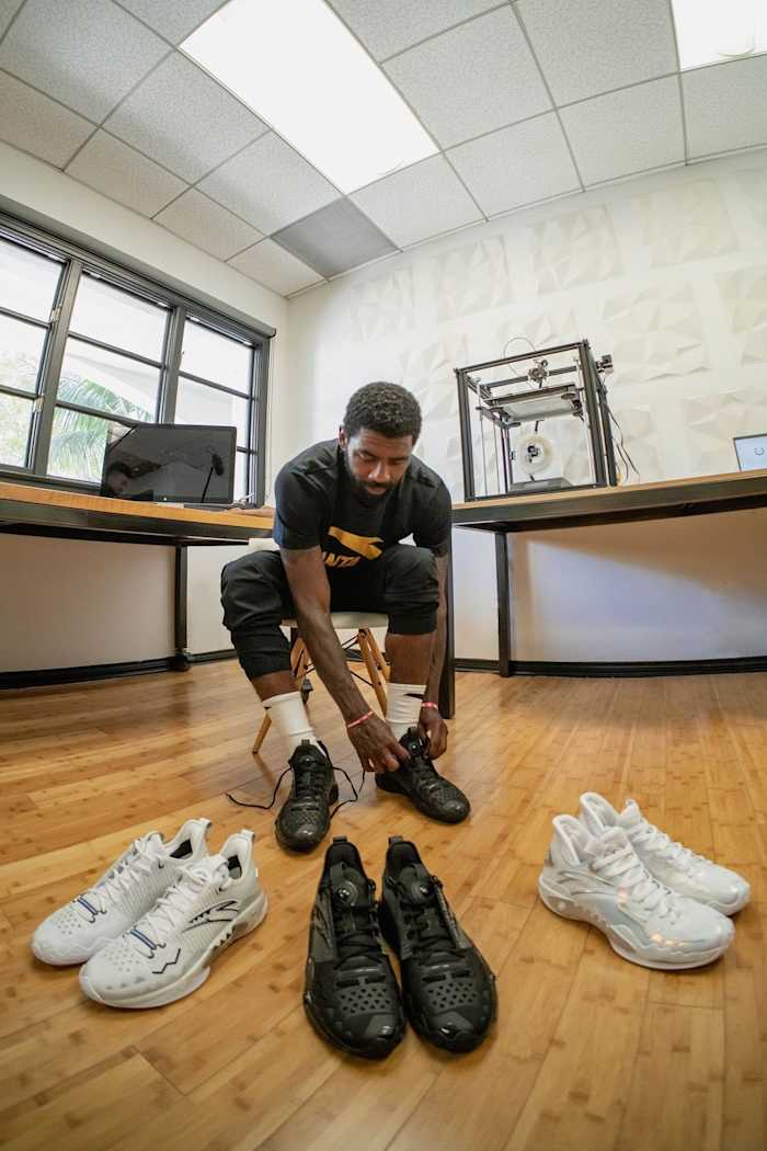 Kyrie Irving poses with ANTA sneakers.