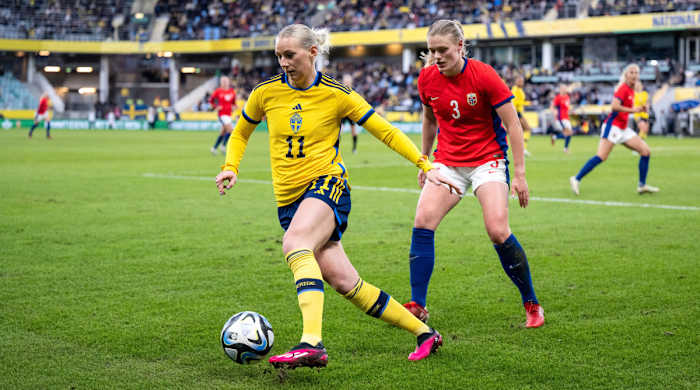 Sweden's Stina Blackstenius controls the ball and holds off Mathilde Harviken of Norway during a friendly.
