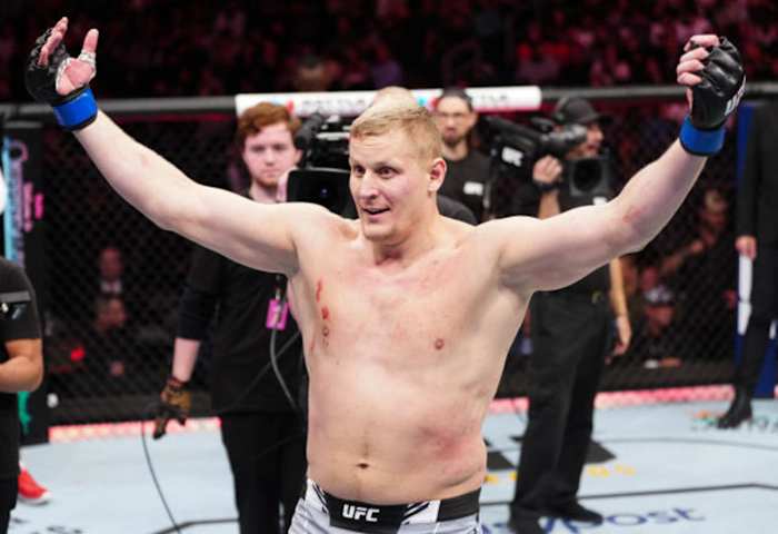 Sergei Pavlovich celebrates inside the UFC Octagon following a victory.