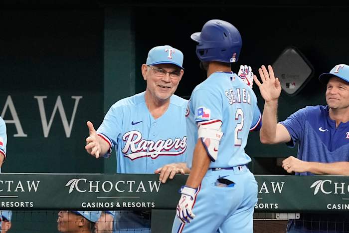 Texas Rangers second baseman Marcus Semien celebrates his home run with manager Bruce Bochy, left, against the Cleveland Guardians during the first inning Sunday at Globe Life Field.