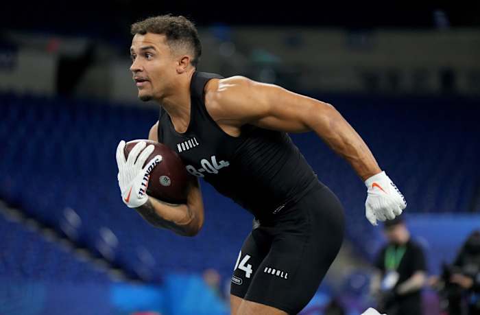 Chase Brown runs with the ball in one hand at the NFL combine