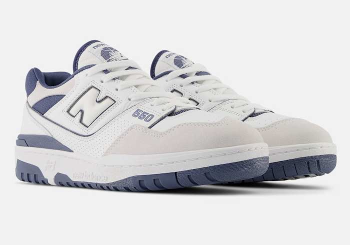Side view of white and indigo New Balance sneakers.