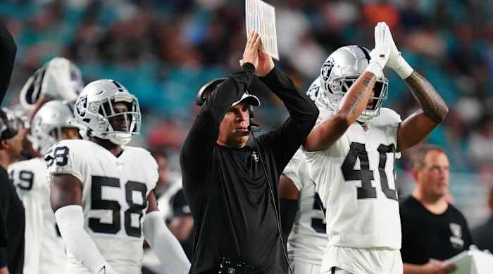 Josh McDaniels signals for a safety