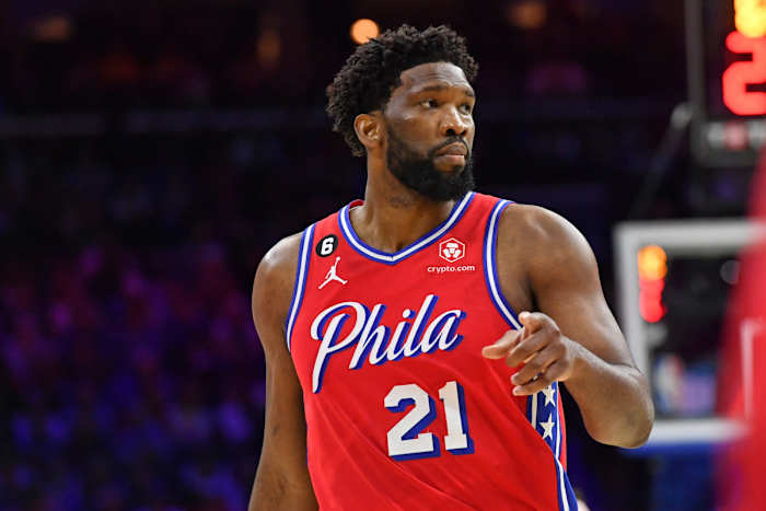 Philadelphia 76ers center Joel Embiid points while looking to the side