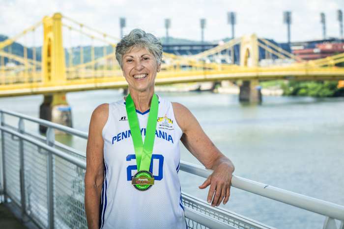 Basketball player Paula Franetti, 67, receives her Humana Game Changer medal at the 2023 National Senior Games in Pittsburgh.