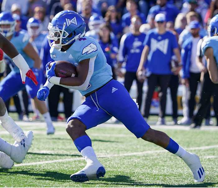 Oct 16, 2021; Lawrence, Kansas, USA; Kansas Jayhawks running back Devin Neal (4) runs the ball against the Texas Tech Red Raiders during the first half at David Booth Kansas Memorial Stadium. Mandatory Credit: Denny Medley-USA TODAY Sports