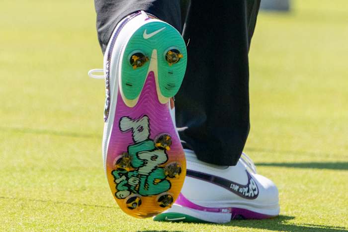 View of Rory McIlroy's white, green, and purple Nike golf shoes.