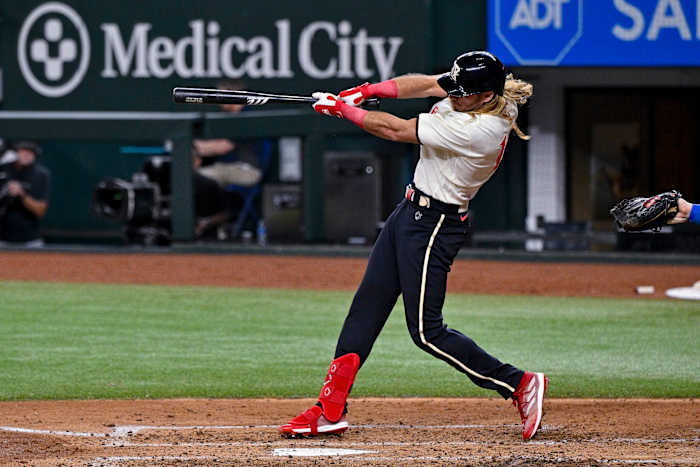 Jul 21, 2023; Arlington, Texas, USA; Texas Rangers left fielder Travis Jankowski (16) drives in a run against the Los Angeles Dodgers during the fourth inning at Globe Life Field. Mandatory Credit: Jerome Miron-USA TODAY Sports