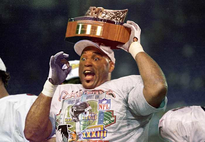 Atlanta Falcons linebacker Cornelius Bennett holds the Halas Trophy after defeating the Minnesota Vikings in the 1998 NFC Championship Game at the Metrodome. The Falcons defeated the Vikings 30-27.