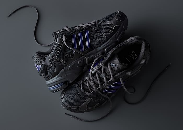 View of Bad Bunny's black and blue adidas sneakers.
