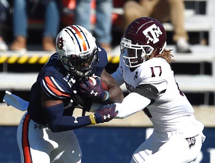 Auburn wide receiver Eli Stove (12) fights to protect the ball from Texas A&M defensive back Jaylon Jones (17) at Jordan-Hare Stadium in Auburn, Ala., on Saturday, Dec. 5, 2020. Auburn Texas A M